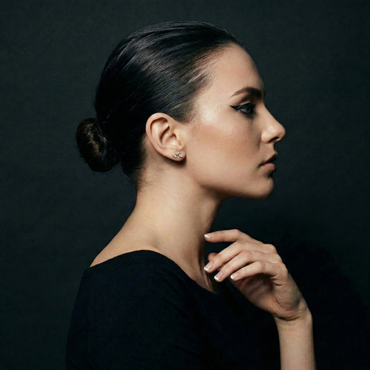 Iris Nova flat-back earring in gold - worn on model ear