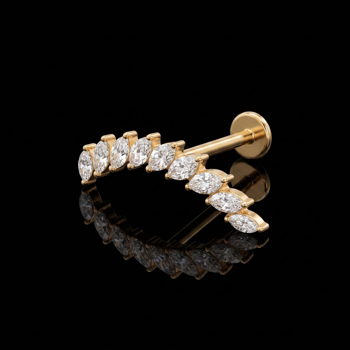 Arcturus gold flat-back earring on a black reflective surface