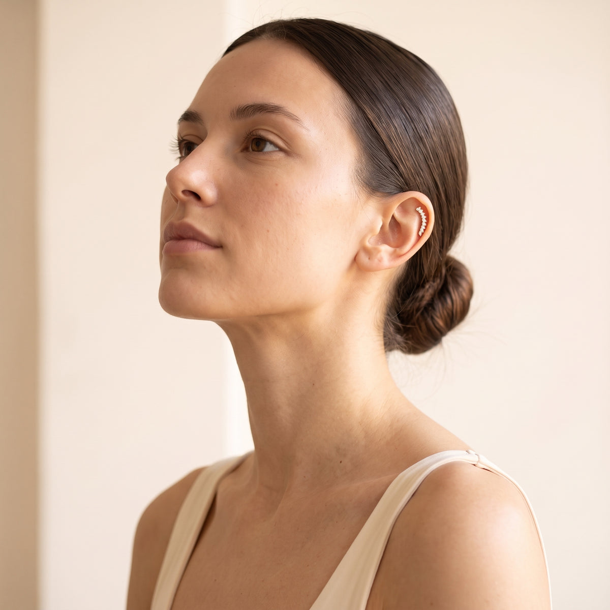 Woman wearing Arcturus gold marquise flat-back earrings
