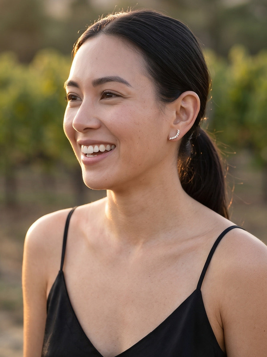 TISTELLA Arcturus gold flat back earring worn at a vineyard at golden hour