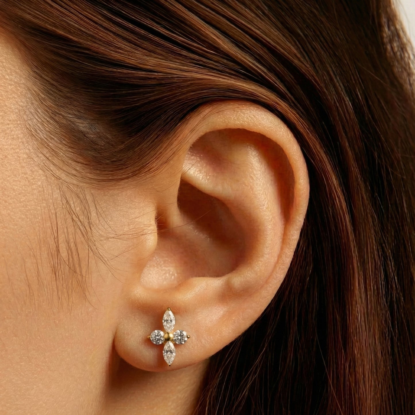 Clover Nova flat-back earring in gold - ear closeup detail