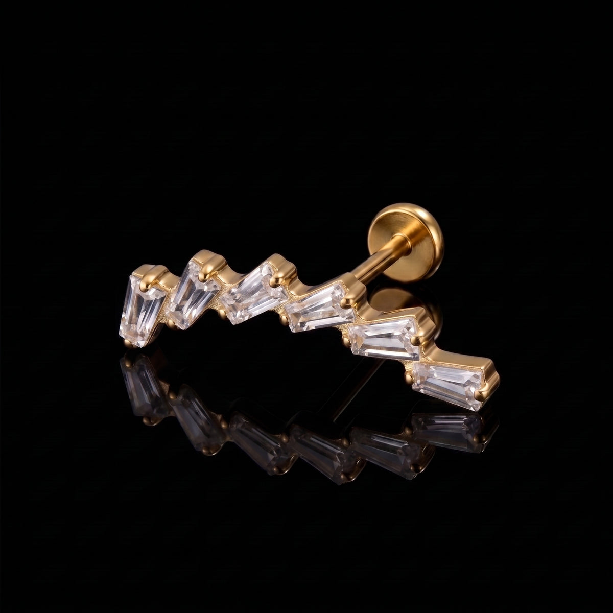 Glacia gold flat-back earring on a black reflective surface