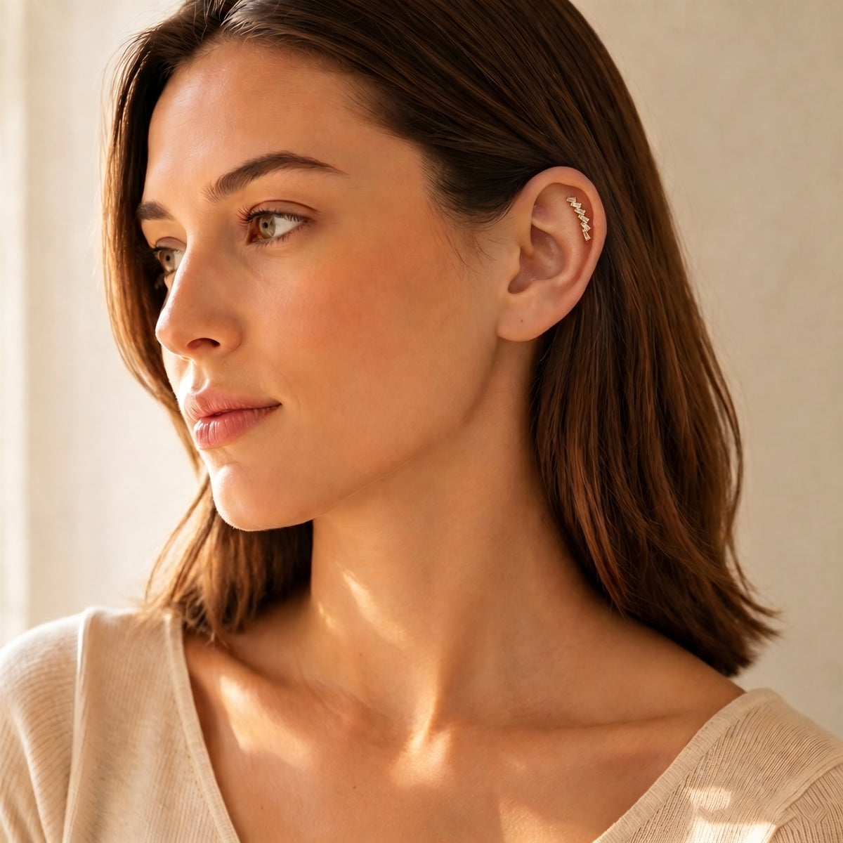 Woman wearing Glacia gold baguette flat-back earrings