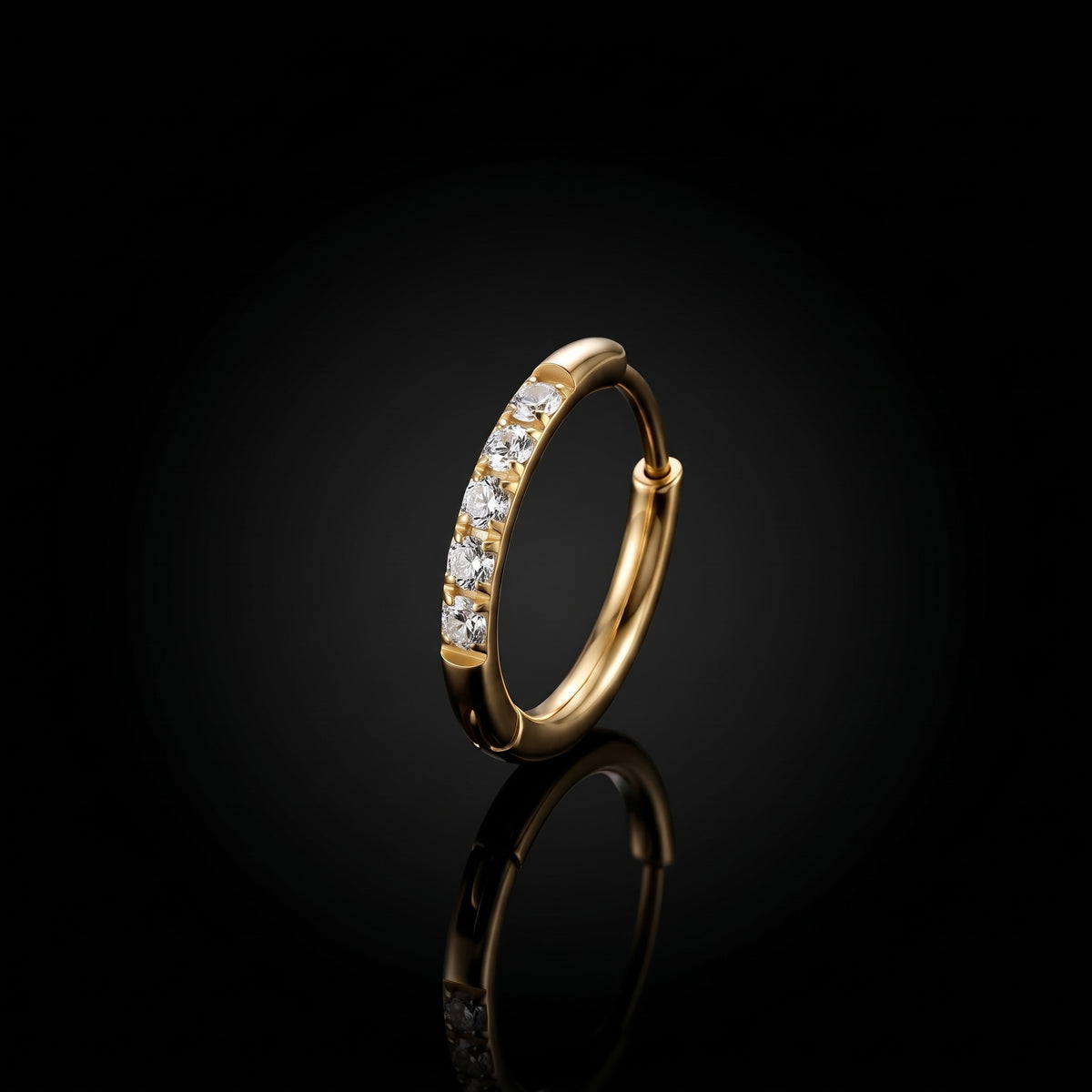 Halo 10mm gold hoop earring on a black reflective surface