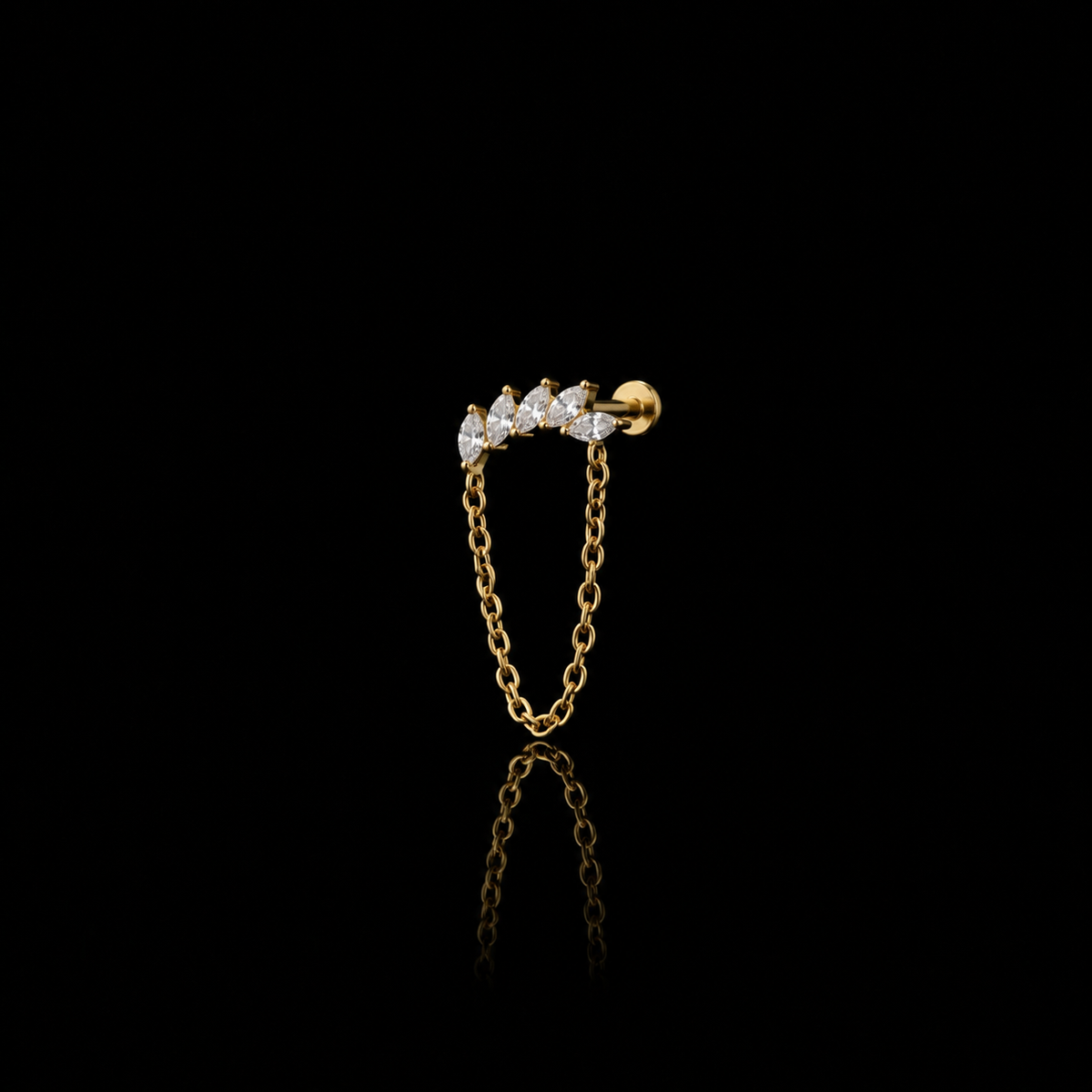 Lyra gold chain flat-back earring on a black reflective surface